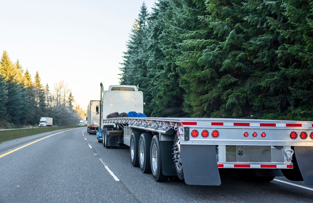 A semi truck convoy moving freight on the interstate