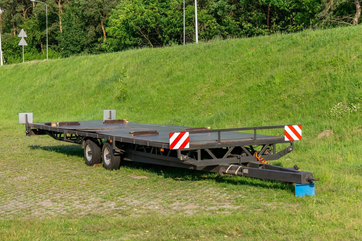 A low-bed trailer parked and ready for service