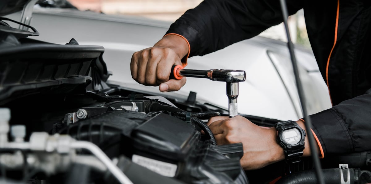 A mechanic servicing a commercial vehicle on site
