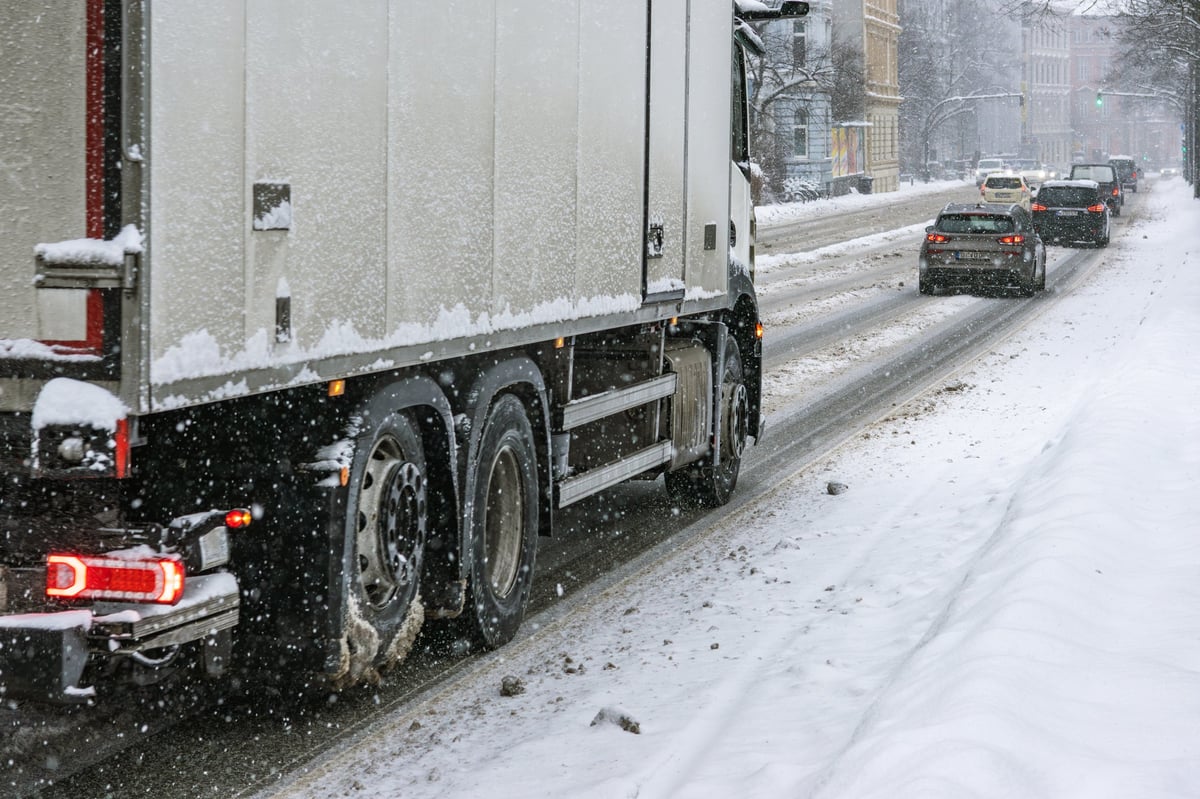 A truck on a snow-covered road in freezing winter conditions