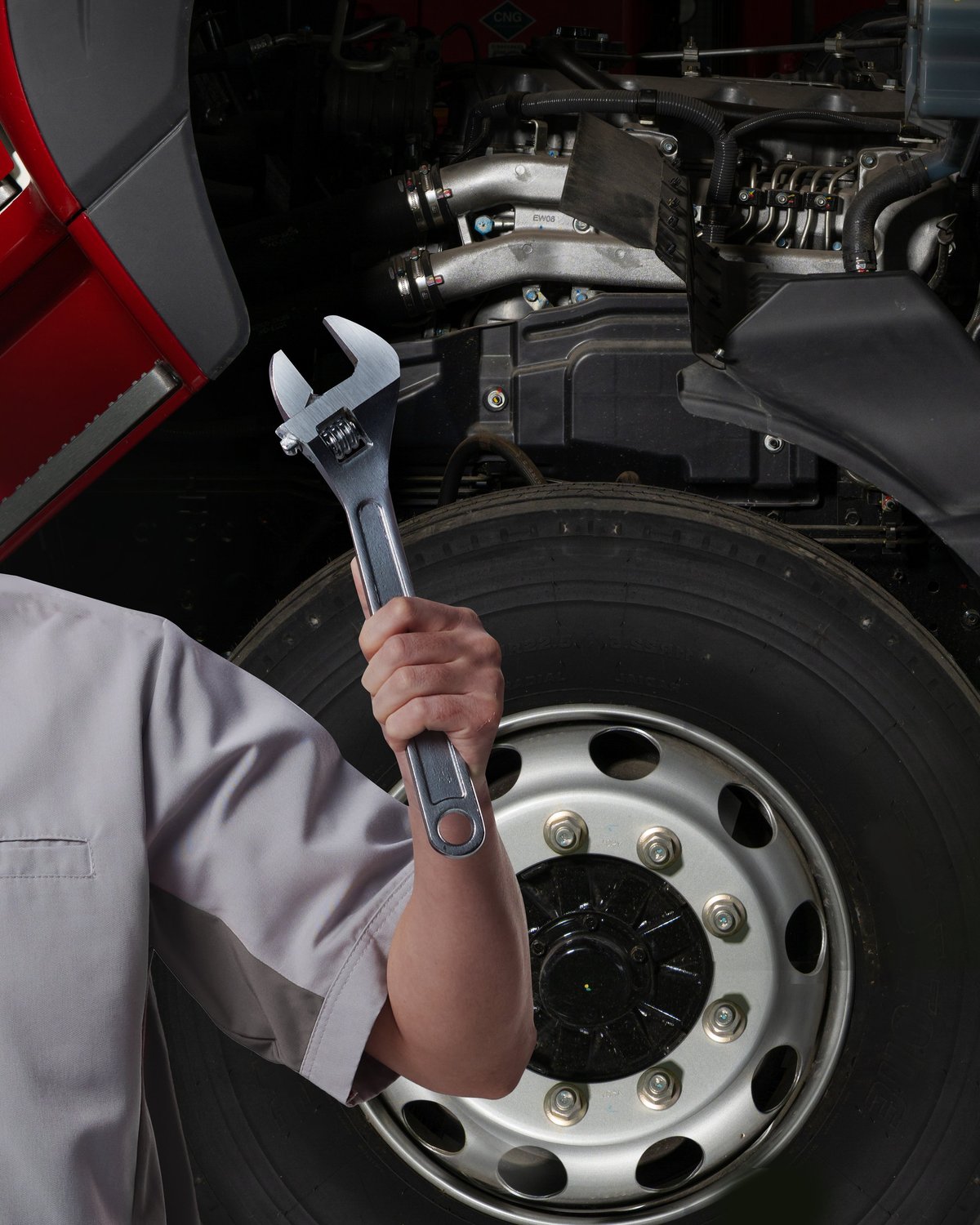 A professional mechanic inspecting a commercial truck engine