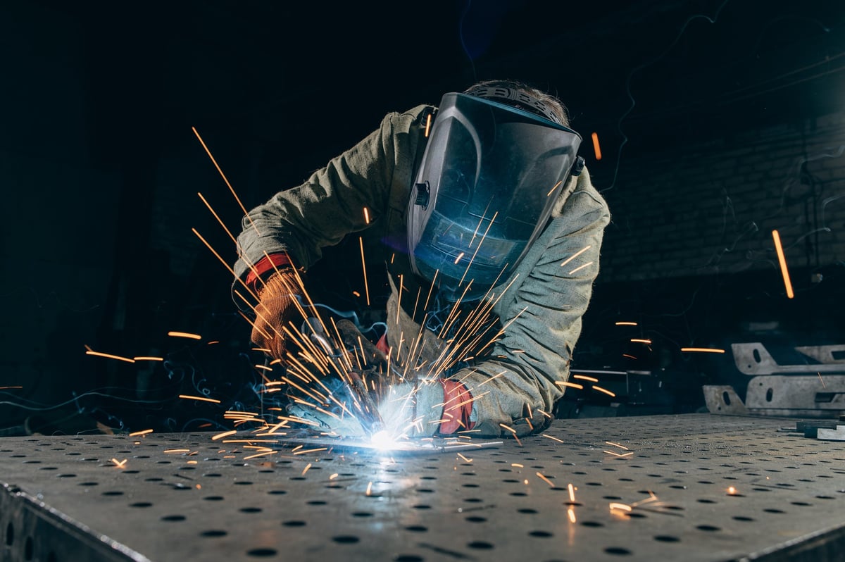 A welder striking bright sparks on a repair job