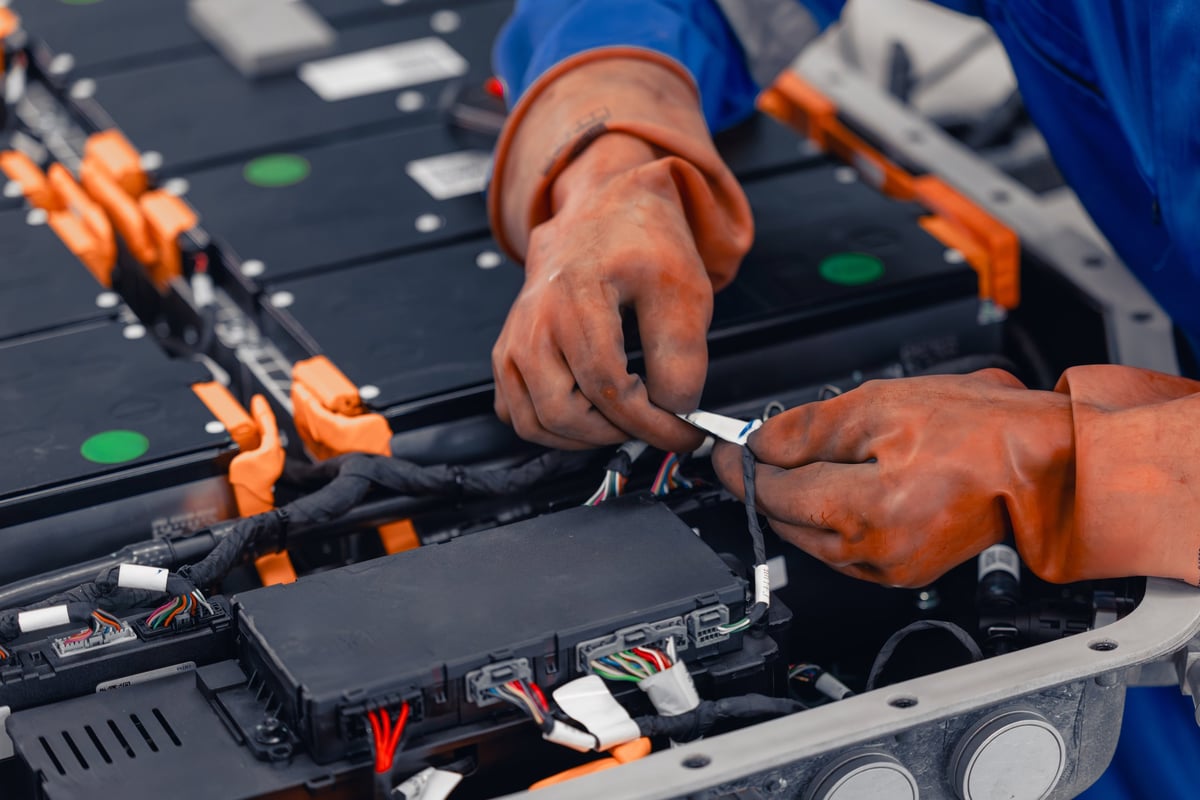 A technician working on a commercial vehicle electrical system